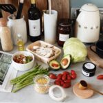 A variety of fresh ingredients and kitchen tools for preparing a healthy meal. - Photo by ready made on Pexels