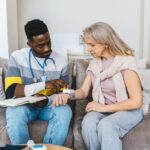 Healthcare professional checking blood pressure of elderly woman in a cozy indoor setting. - Photo by Antoni Shkraba on Pexels